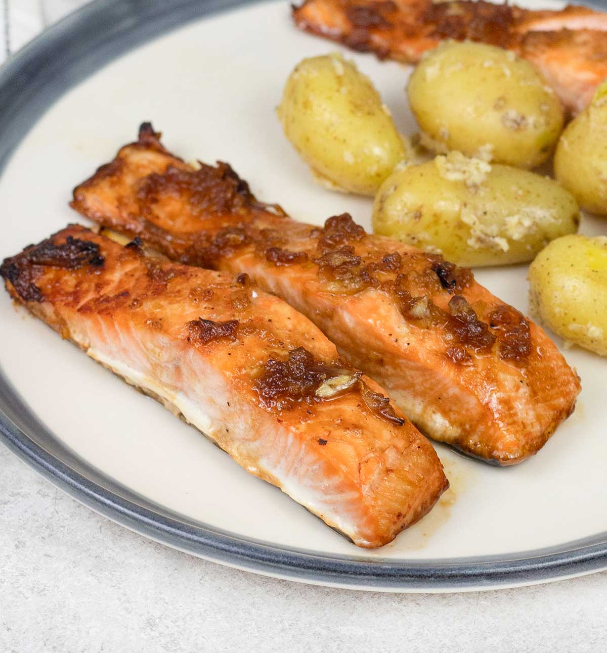 Baked Honey Glazed Salmon and potatoes on a serving plates