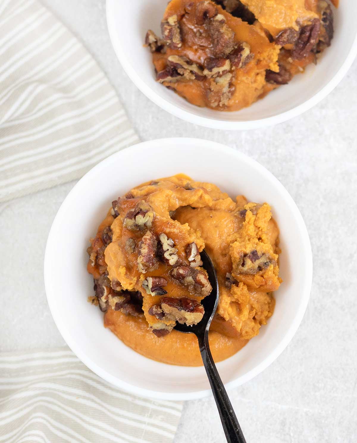 Pumpkin Custard topped with pecans in a serving plate