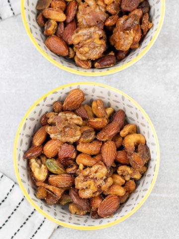 2 bowls filled with Honey Roasted Mixed Nuts.