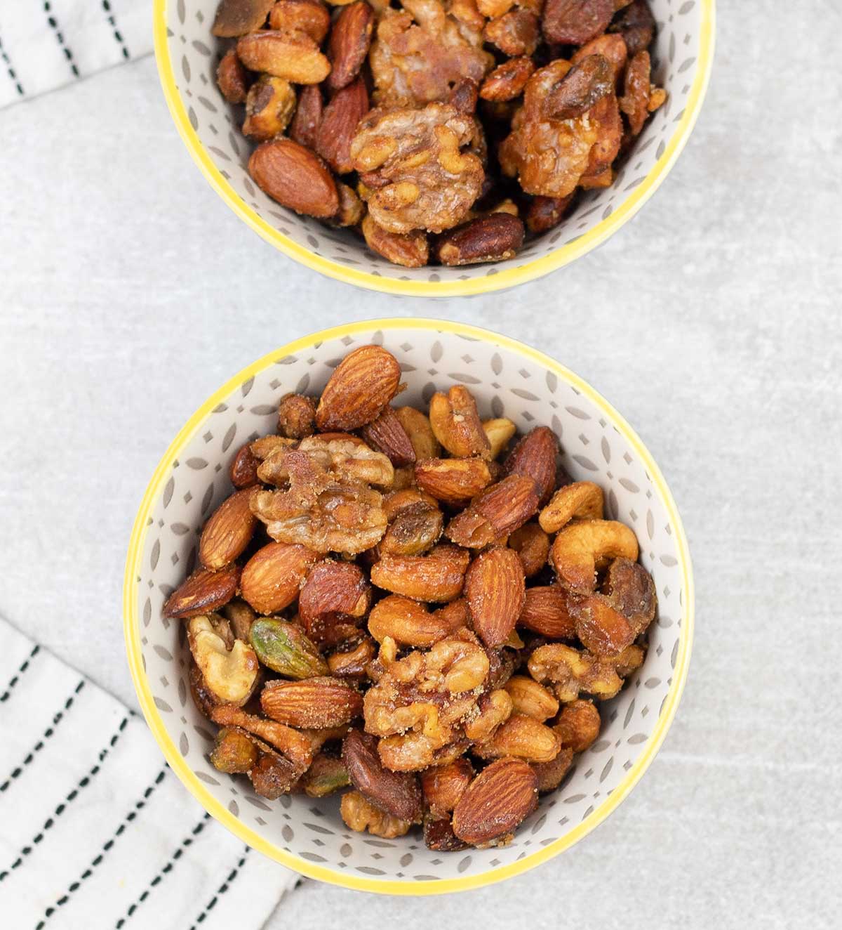 2 bowls filled with Honey Roasted Mixed Nuts.