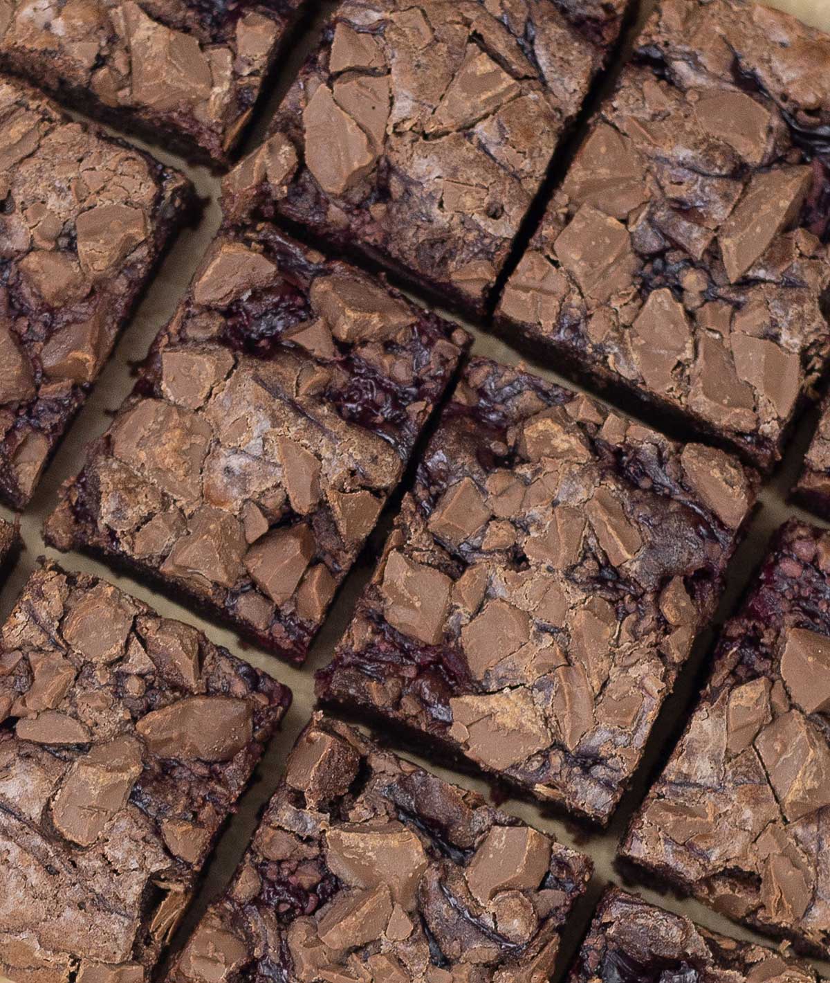 overhead shot of brownies with cherry pie filling cut into squares.