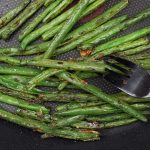Pan fried green beans in a large skillet.