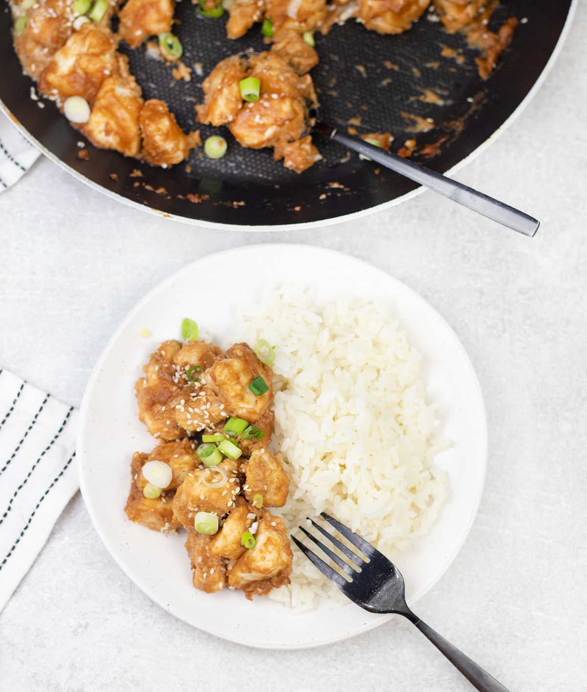 Peanut butter chicken and rice in a plate.