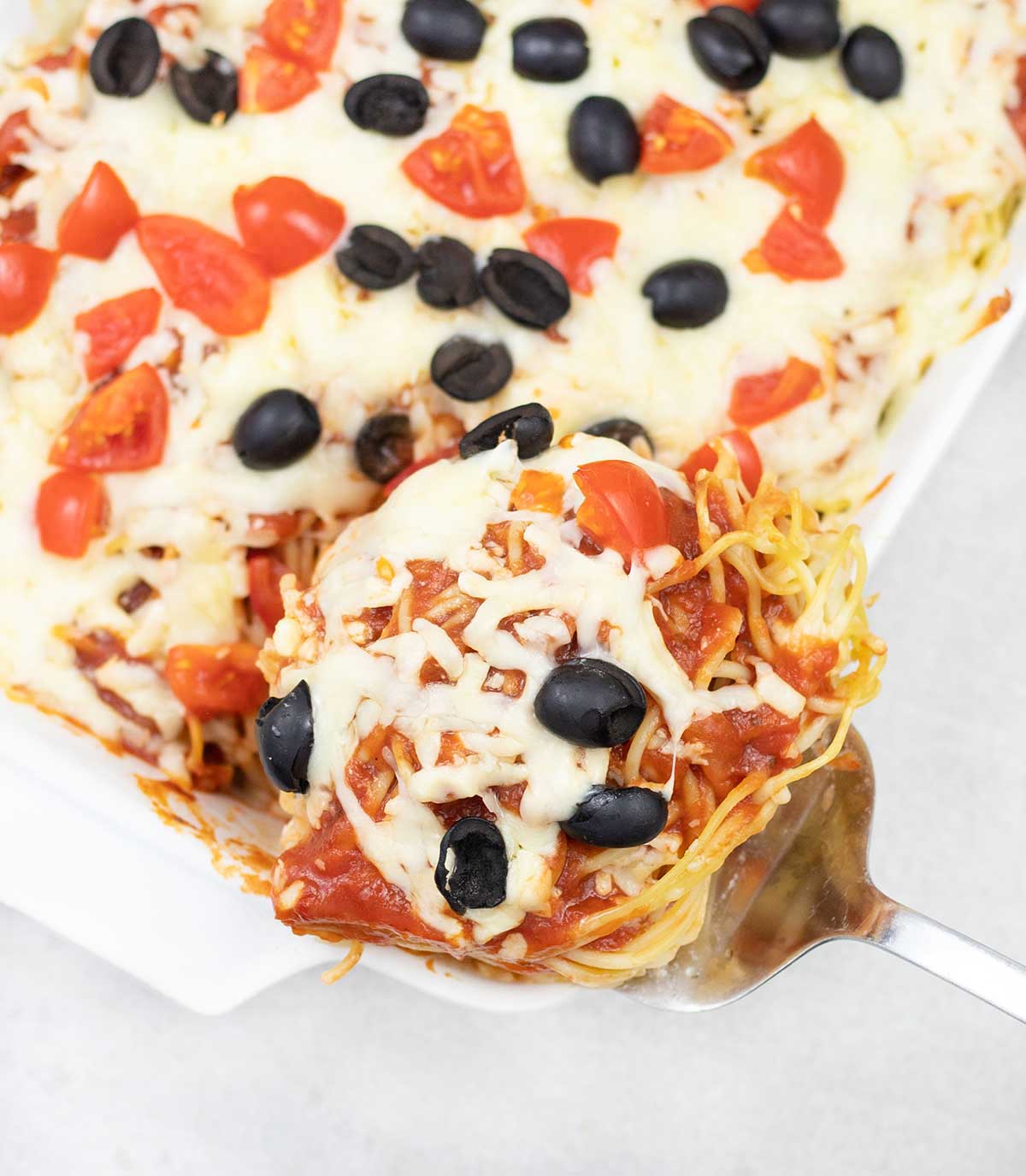 Pizza spaghetti bake slice.