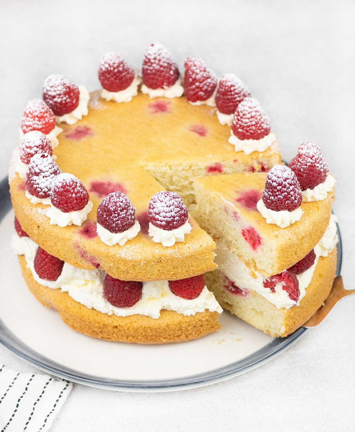 Raspberry sponge cake in a serving plate.