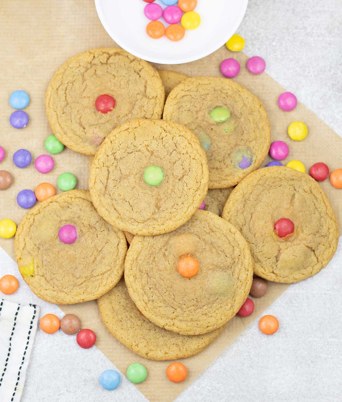 Smarties cookies and some Smarties scattered around.