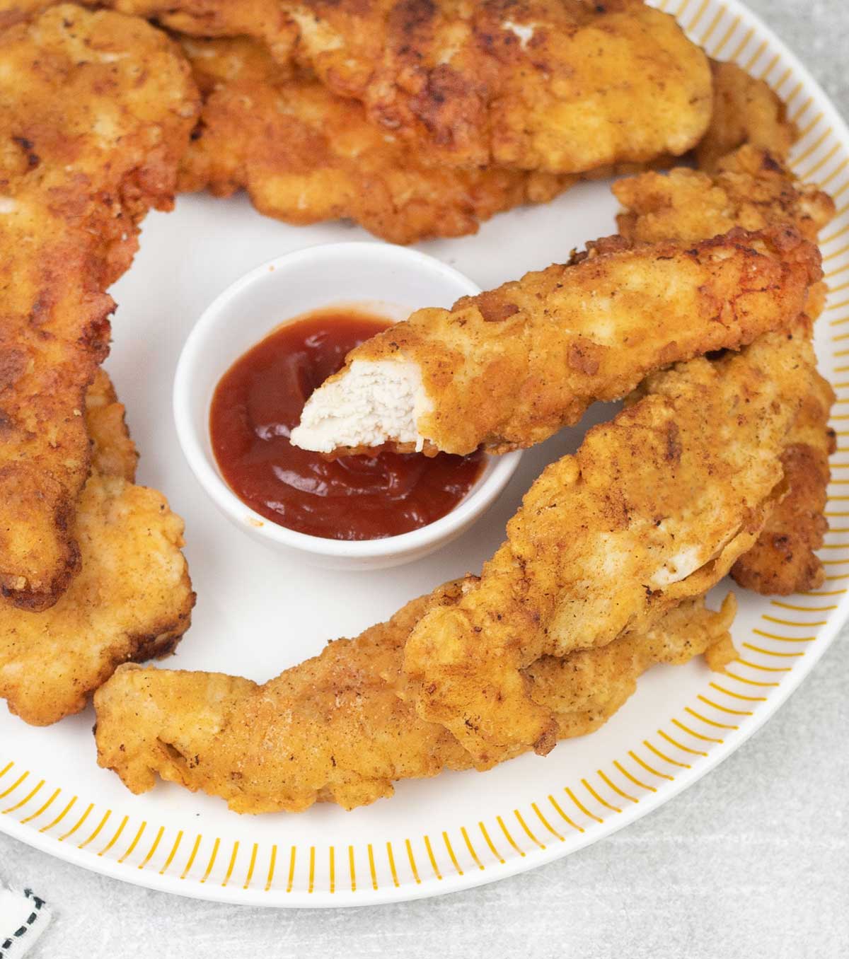 Eat one of the fried chicken tenders.