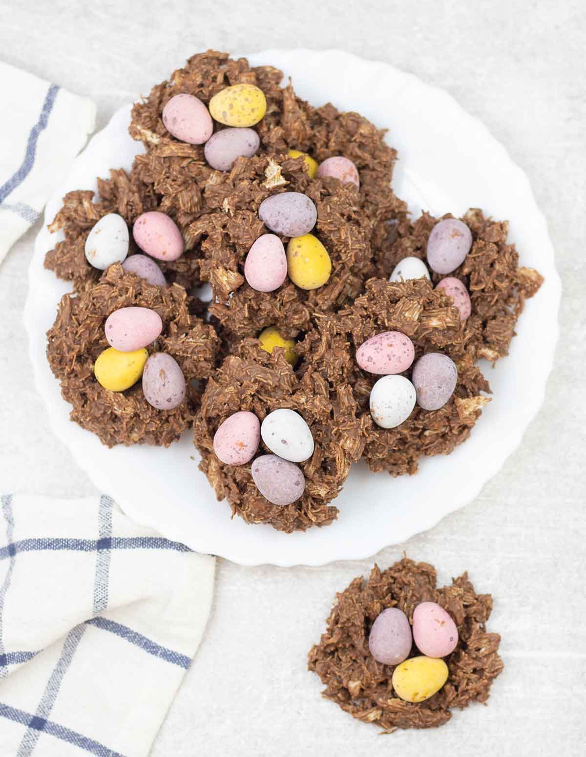 Easter nests topped with Easter mini eggs in a plate.