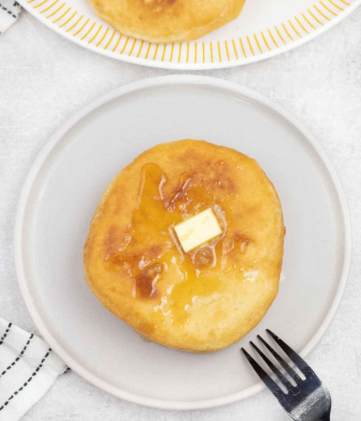 Caribbean johnny cakes topped with butter and syrup.