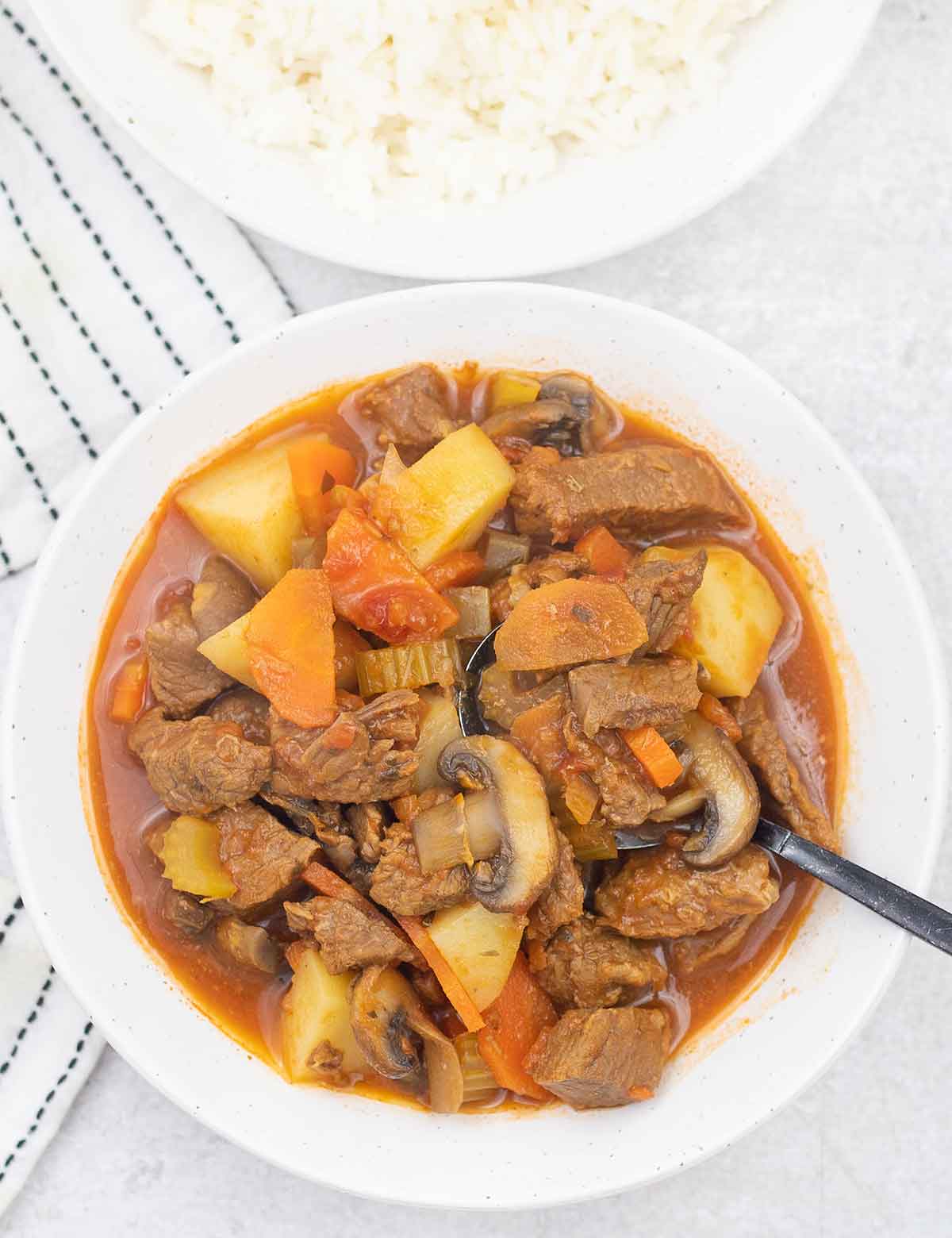 Beef stew with tomato sauce in a bowl.