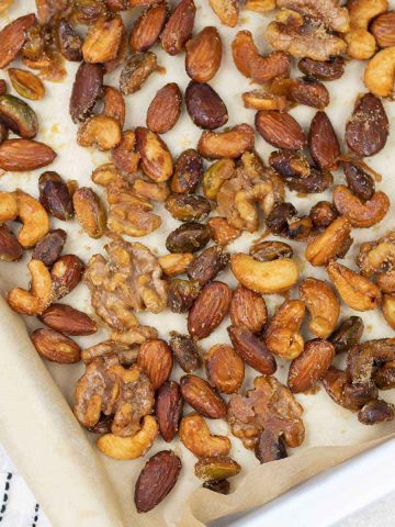 honey roasted mixed nuts on a baking pan.