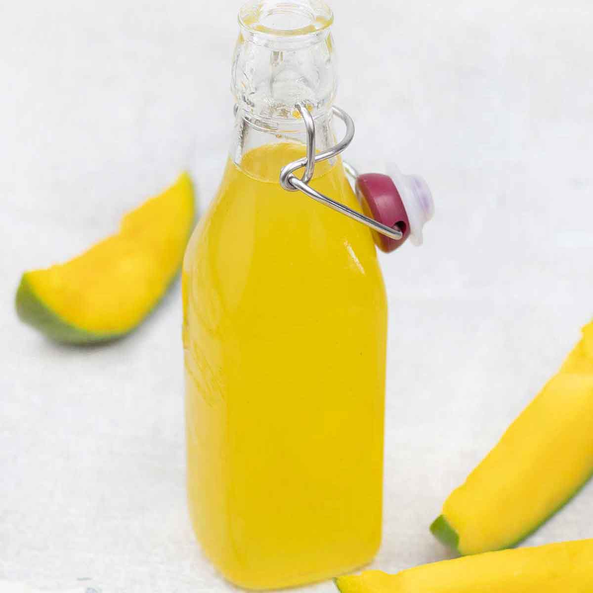 Mango syrup in a glass bottle.