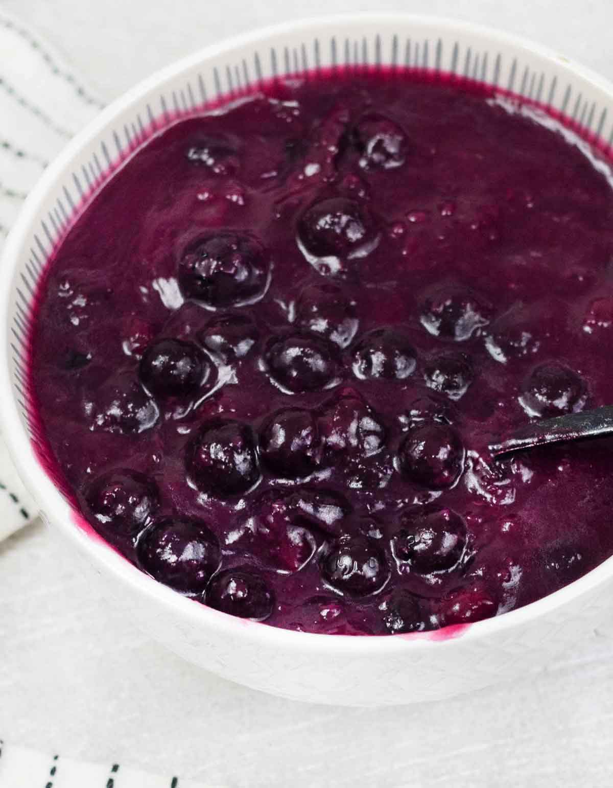 A spoonful of homemade blueberry cake filling.