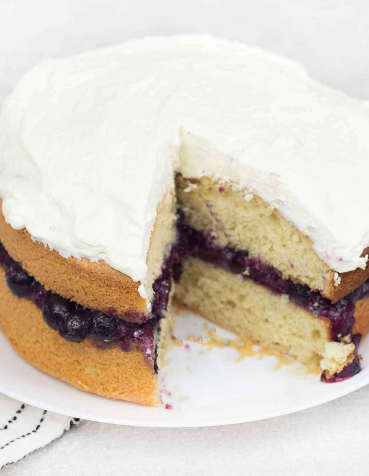2 layers cake stuffed with blueberry cake filling and topped with whipped cream.