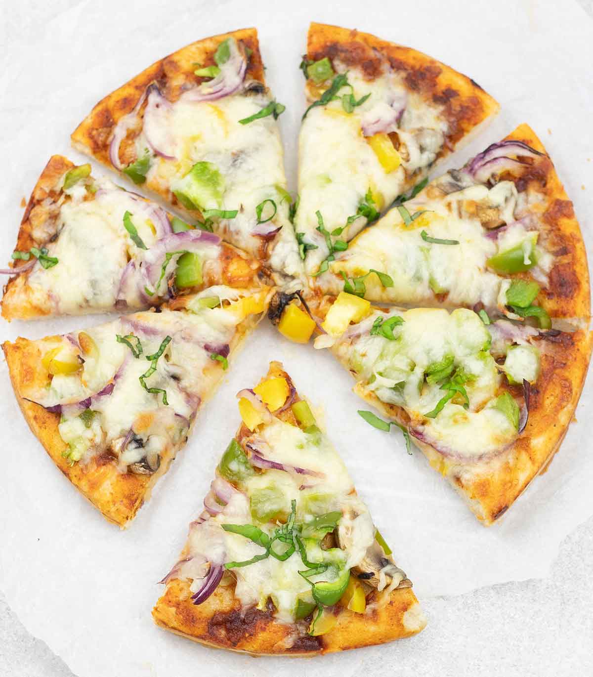 Thai curry pizza cut into slices.