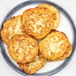 Fried mashed potato patties on a serving plate.