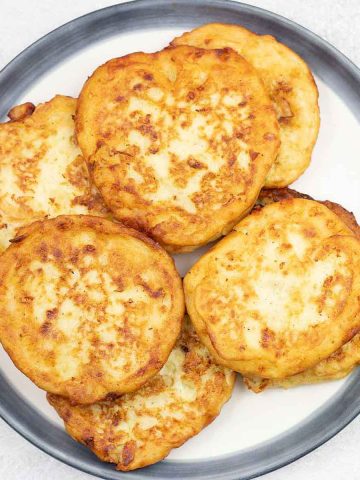 Fried mashed potato patties on a serving plate.