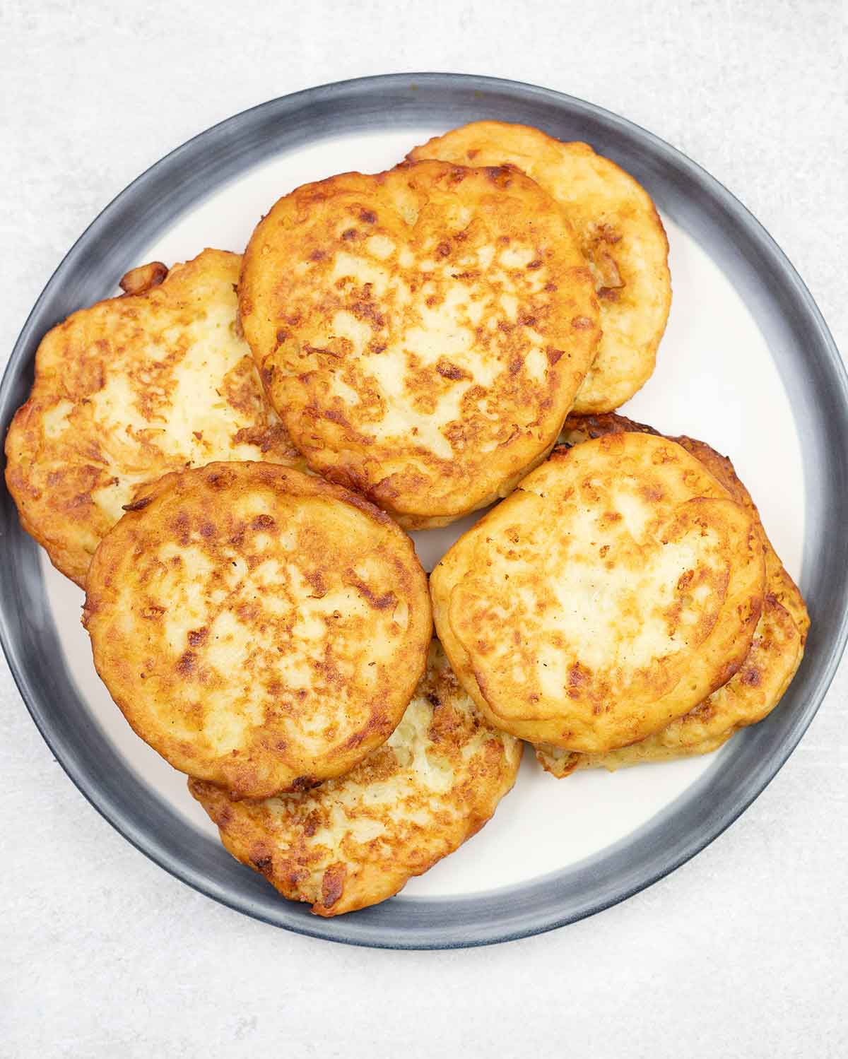 Fried mashed potato patties on a serving plate.