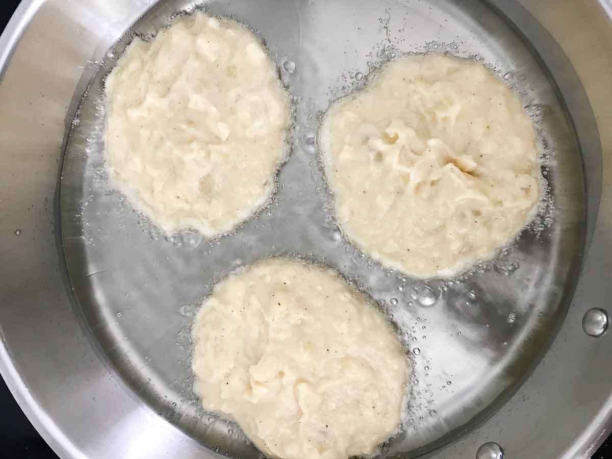 Fry the potato patties in the hot oil.