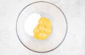 The egg yolks and sugar in a mixing bowl.