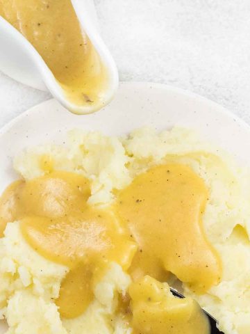 homemade chicken gravy on top of mashed potatoes.