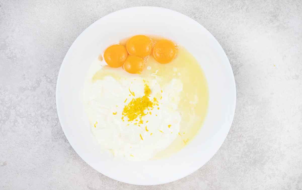 mix the egg yolks with condensed milk, lemon juice and, zest and Greek yogurt.