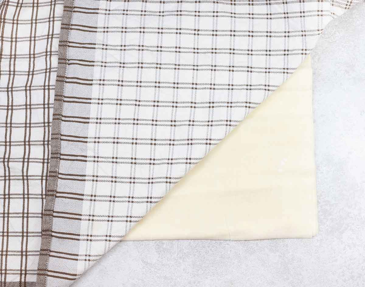 Phyllo pastry sheets covered with a kitchen towel.