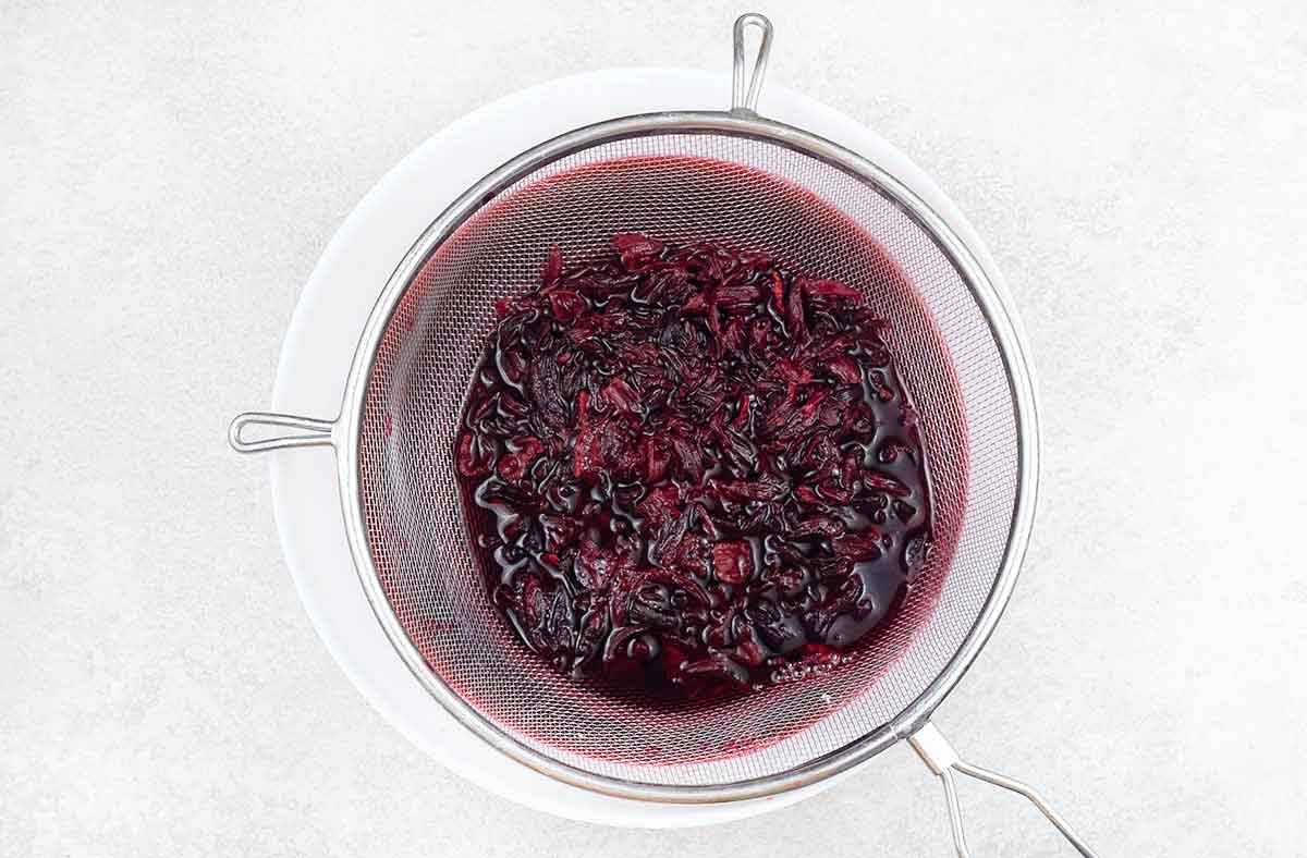 Set a fine-mesh strainer over a large bowl or pot and pour the tea through the strainer.