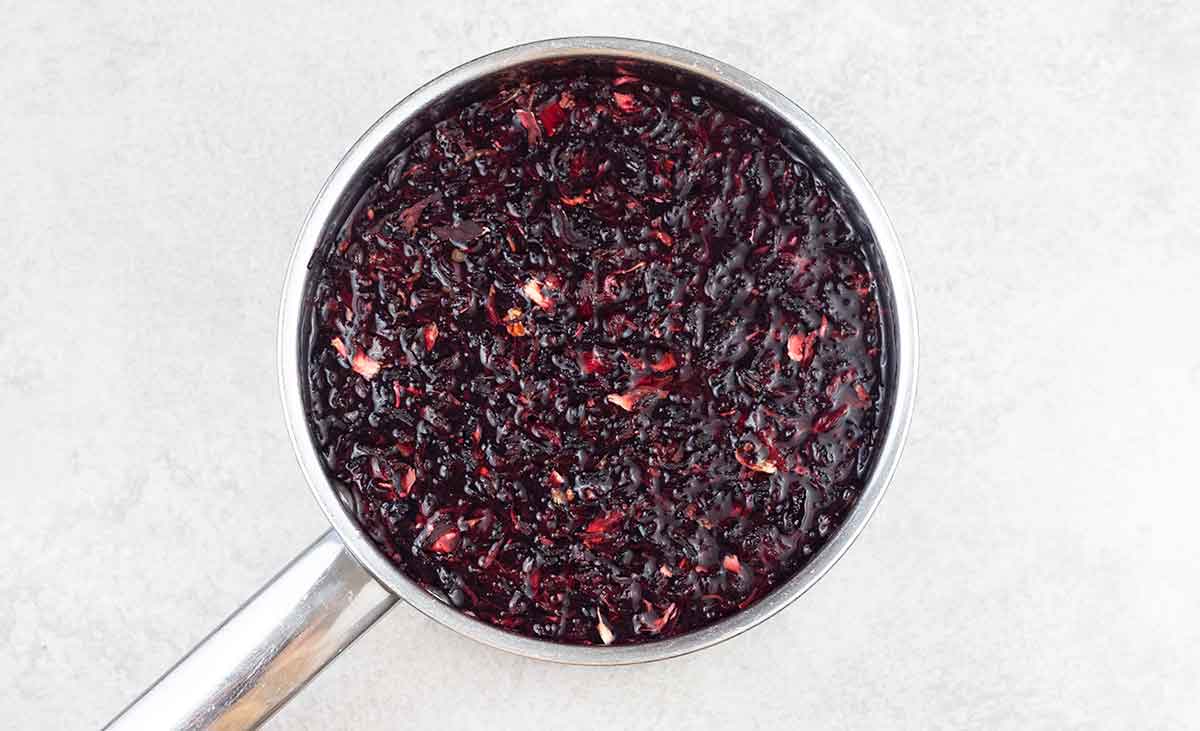 In a saucepan, add the dried hibiscus flowers and water over high heat.