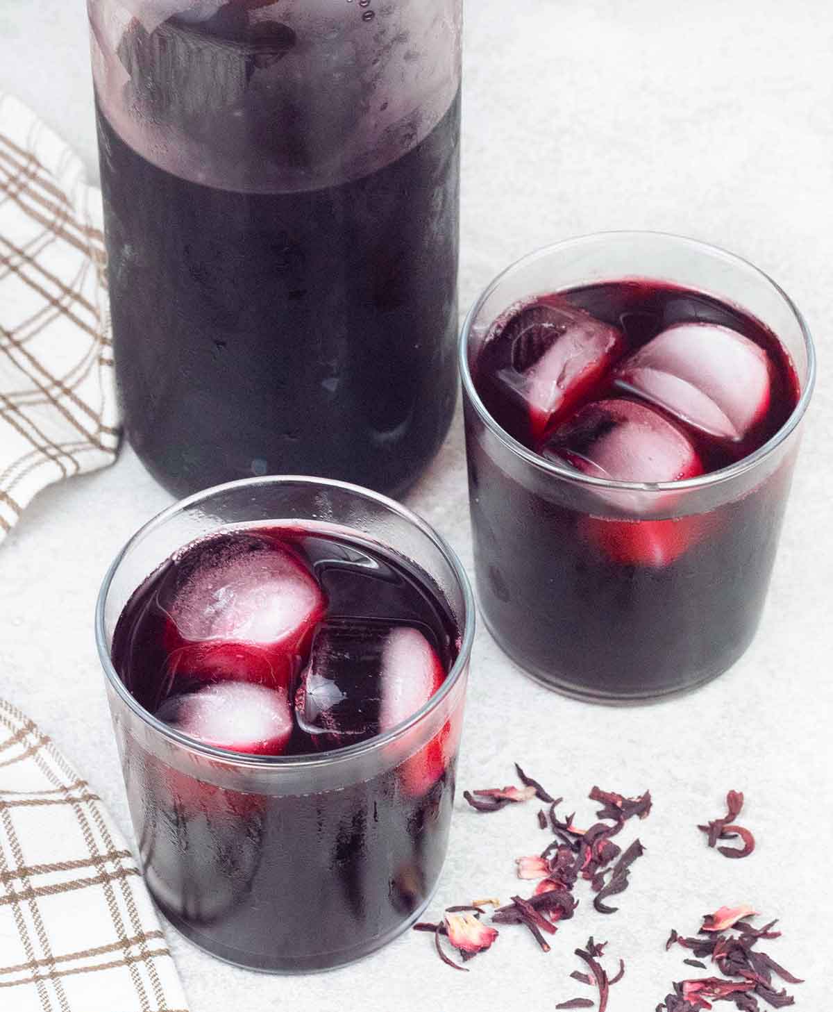 karkade (hibiscus tea) in 2 glasses and a bottle.