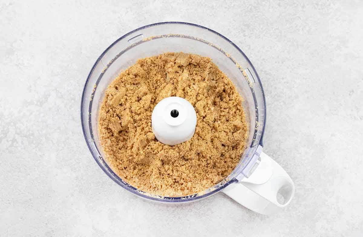 In the food processor, add the biscuits and blitz until crumbs.