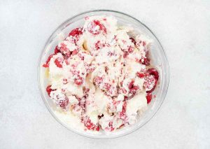 fold the whipped cream into the cream cheese mixture, and stir in the raspberries.