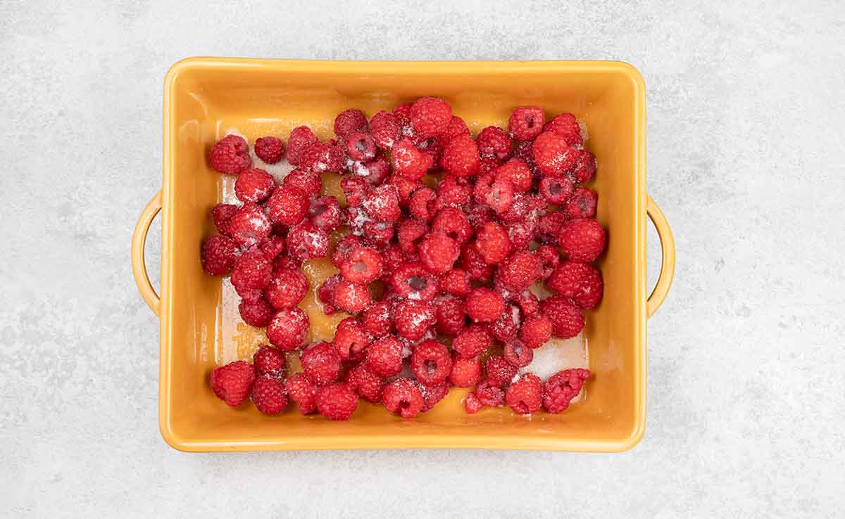 Mix the granulated sugar and raspberry in a baking dish.