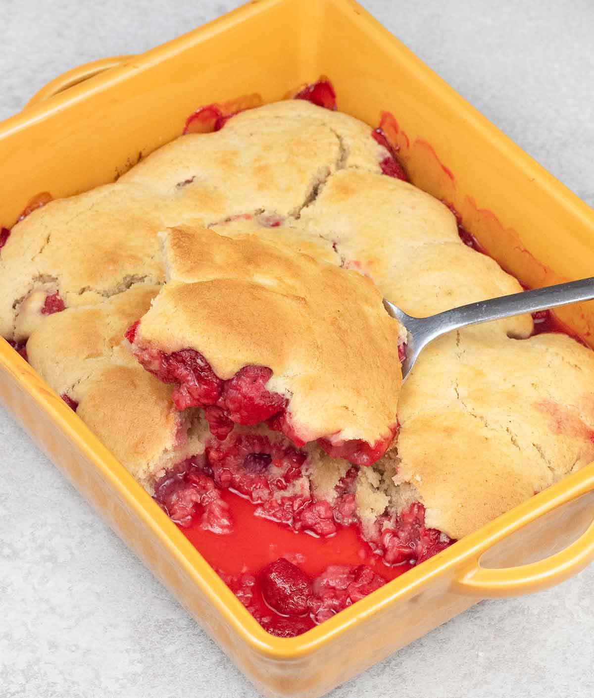 Raspberry cobbler in a baking dish.