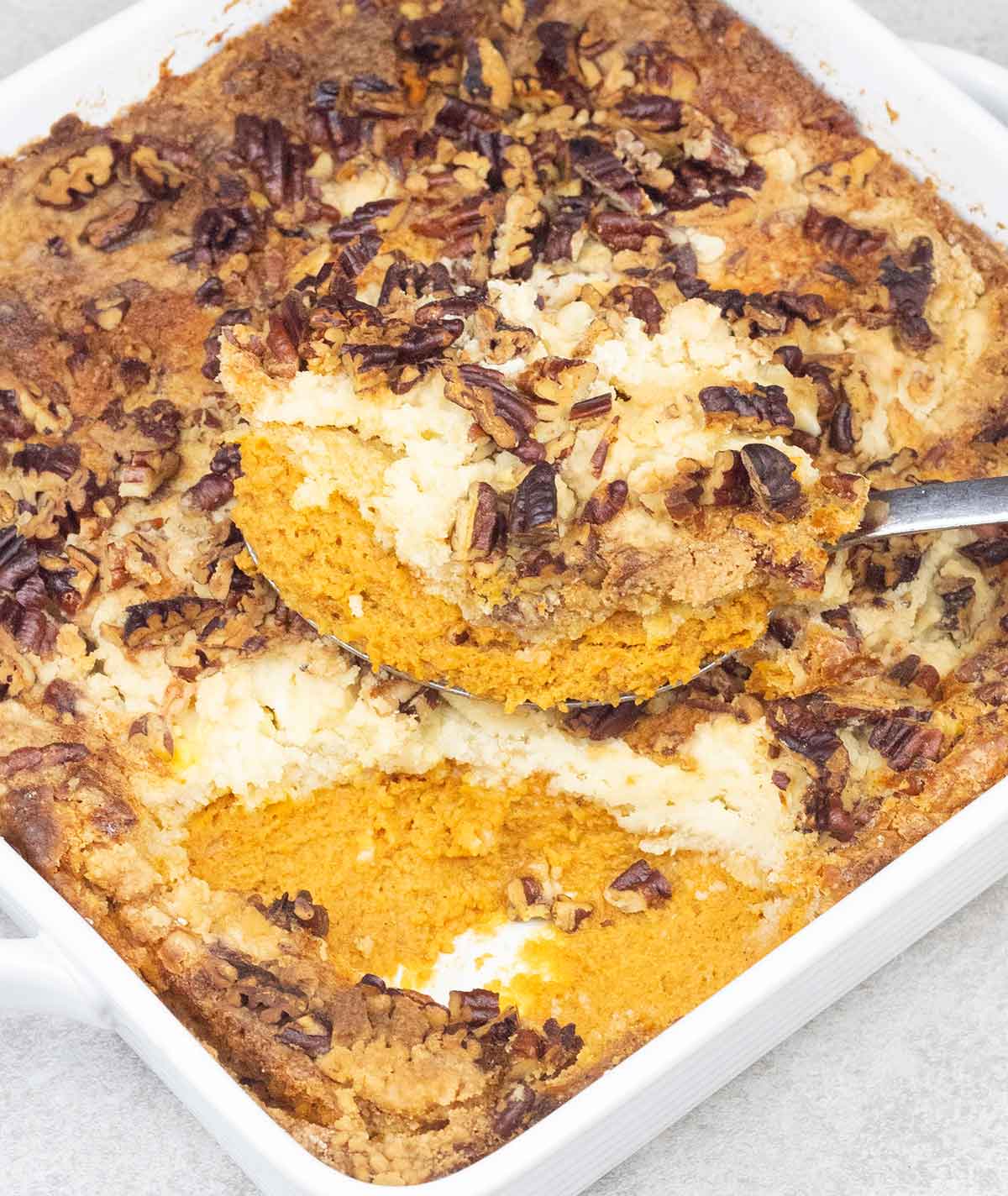 pumpkin dump cake topped with pecan.