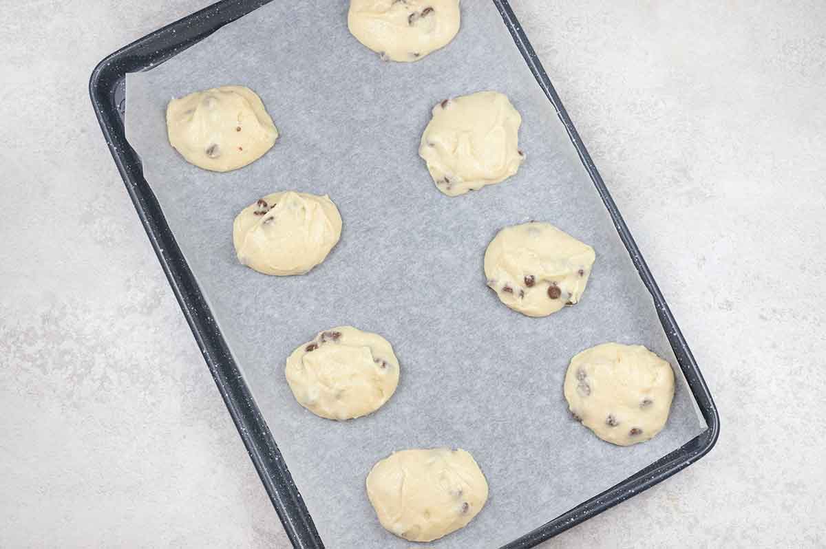 Scoop the cookie batter using a cookie scoop into the baking sheets, leaving space between them.