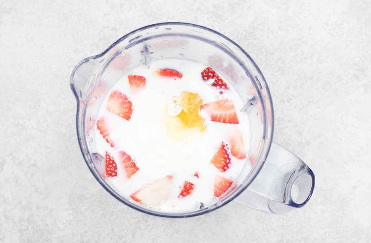 In a blender, add yoghurt, milk, strawberry and honey.