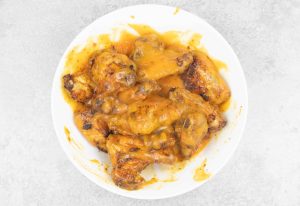 In a bowl, top the wings with the sauce, mix until all the chicken are evenly coated.