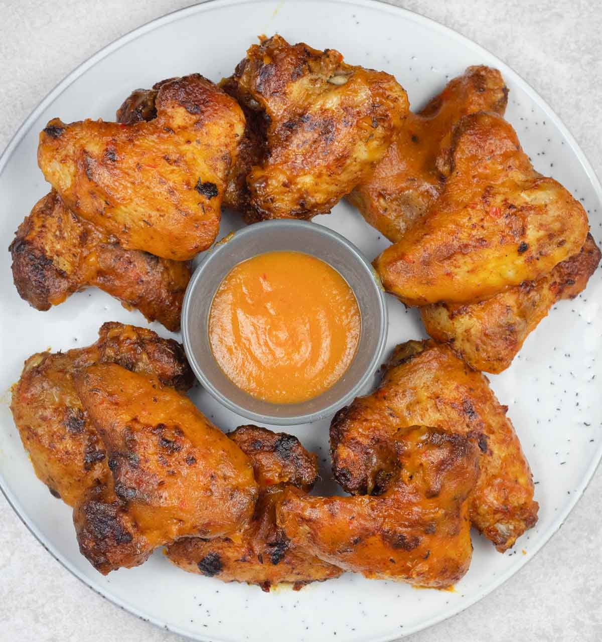 Mango habanero wings in a serving plate.