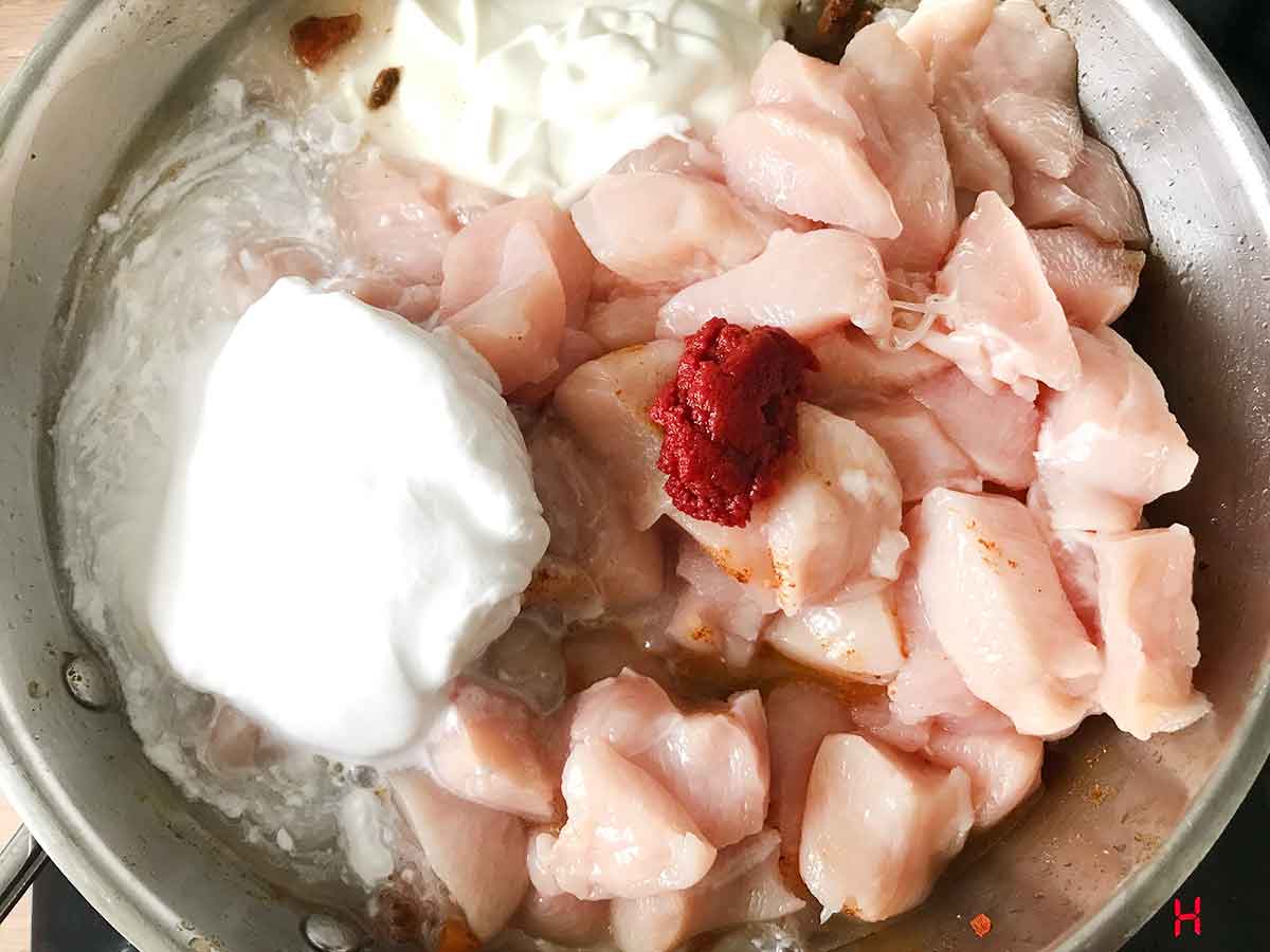 Add the chicken breast chunks, yogurt, tomato paste, and coconut milk.