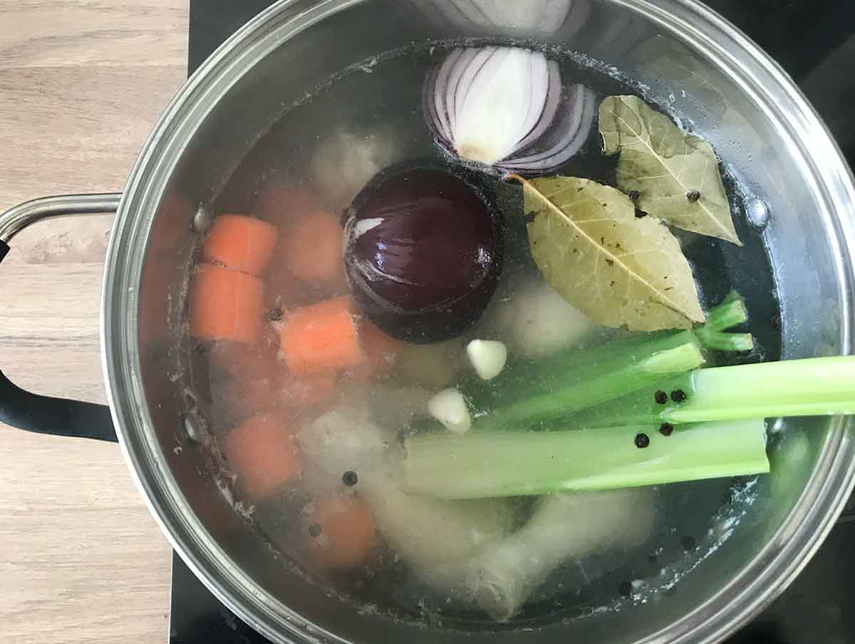 Add the onion, garlic, celery, carrots, bay leaves and peppercorns.