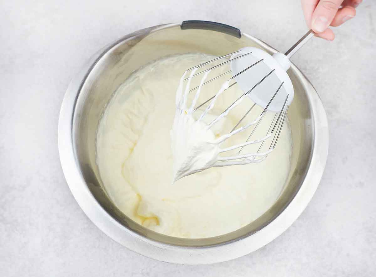 Beat heavy cream and the powdered sugar with the stand mixer until thick and stiff peak forms.