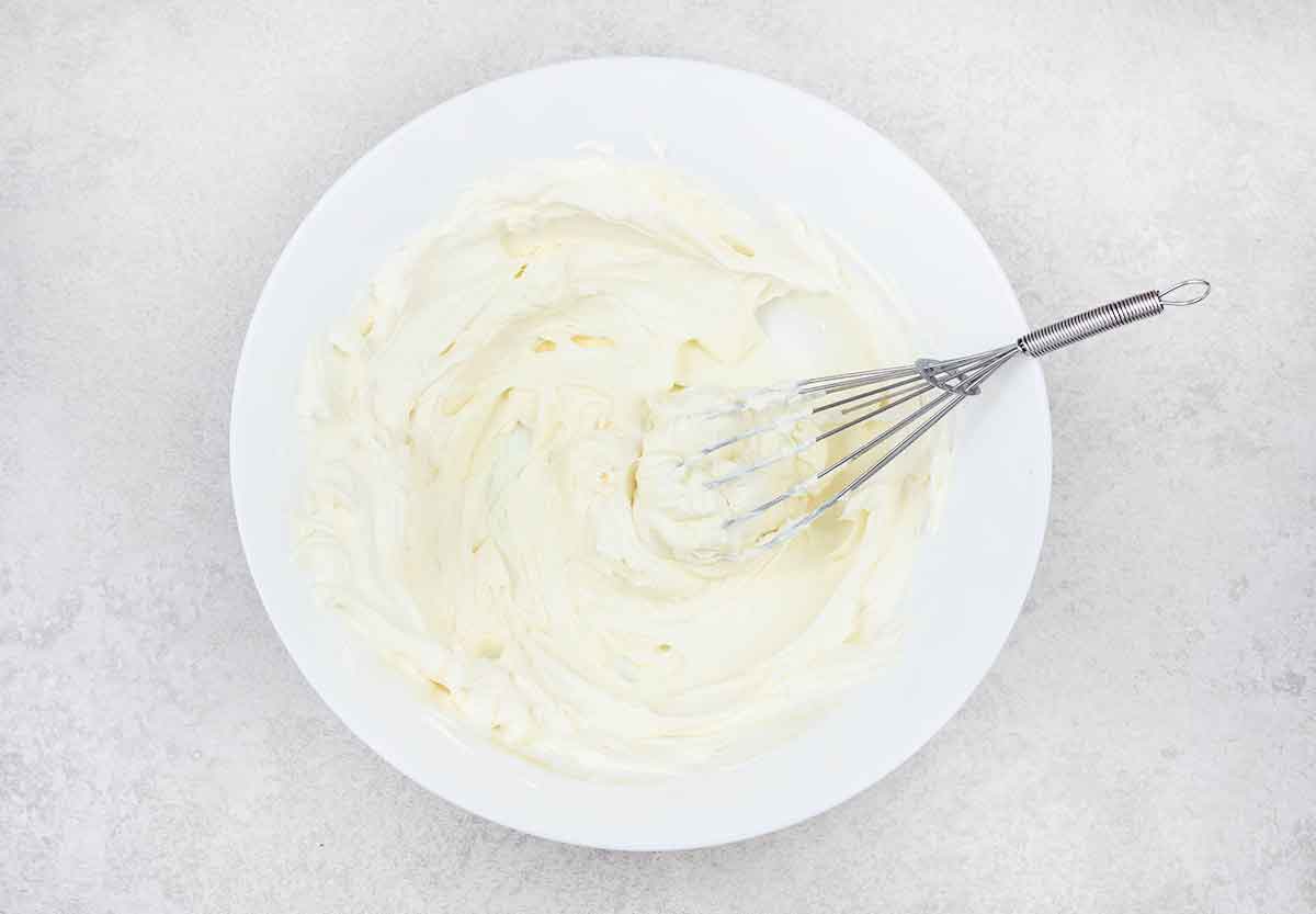 add cream cheese and vanilla extract and whip until fluffy and lump-free.