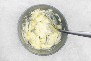 In a small bowl, mix the softened butter with the minced garlic and fresh thyme until well combined.