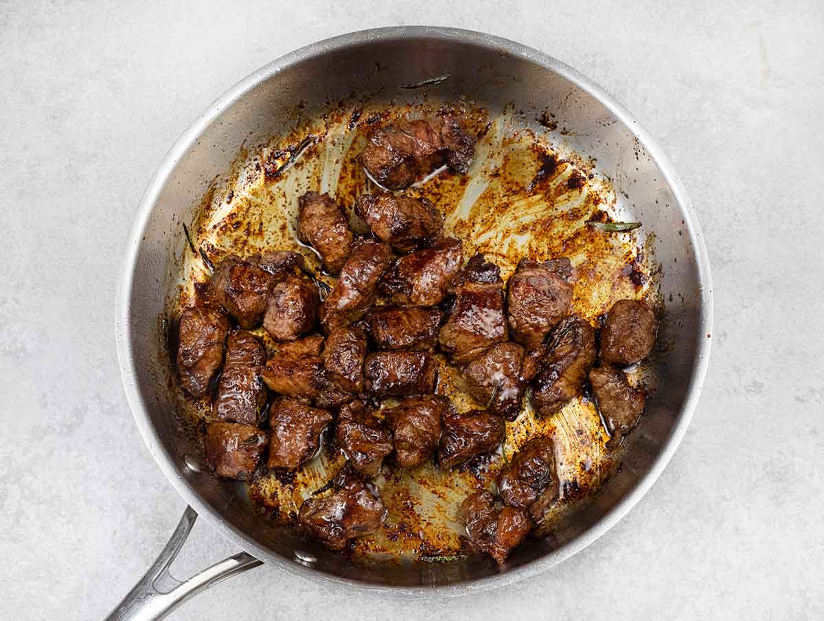 Sear the steak in the hot oil on both sides for about 4 to 5 minutes.