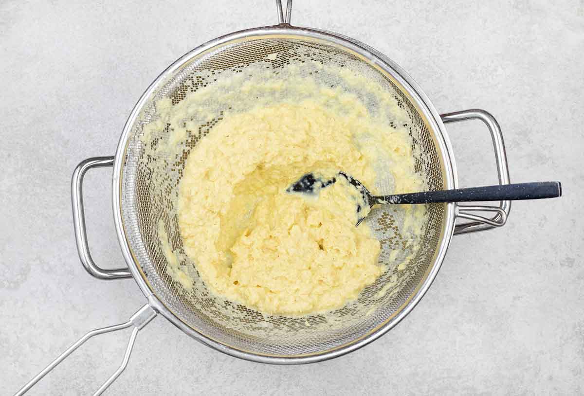 Strain the corn mixture through a fine-hole mesh strainer into a small pot.