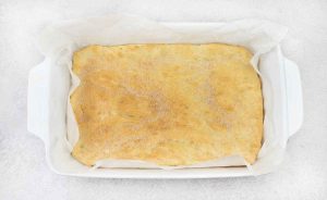 Spread the mixture into the baking pan and bake until golden brown.