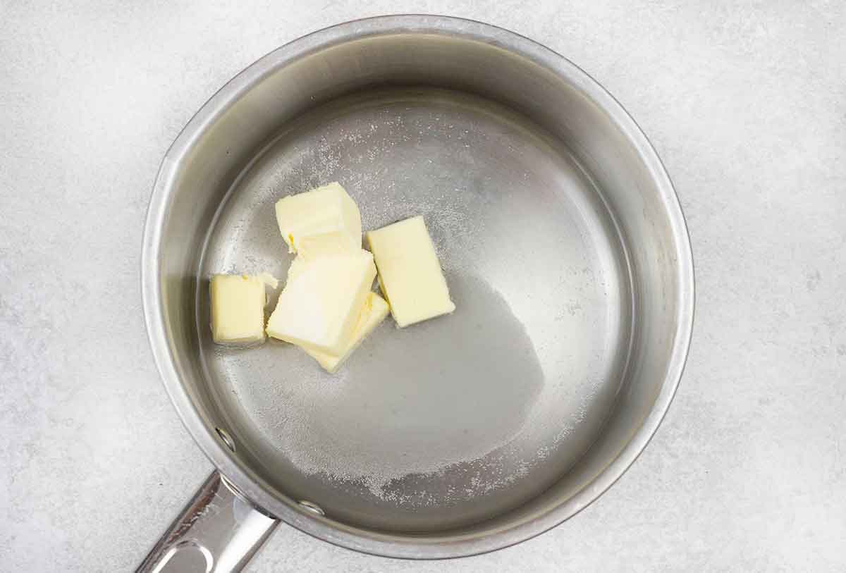 In a saucepan, add butter, sugar and water over low.