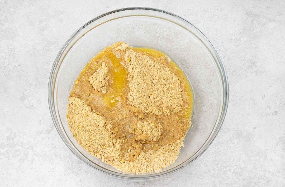 Transfer the crumb mixture into a mixing bowl, add the melted butter.