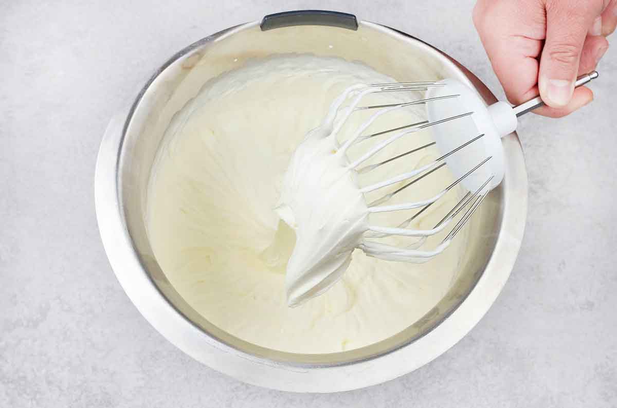 whisk the heavy cream and icing sugar with the electric mixer until a stiff peak forms.
